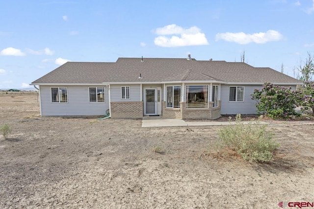 19496 E Rd, Delta, CO 81416 - back of property with a patio area and brick siding
