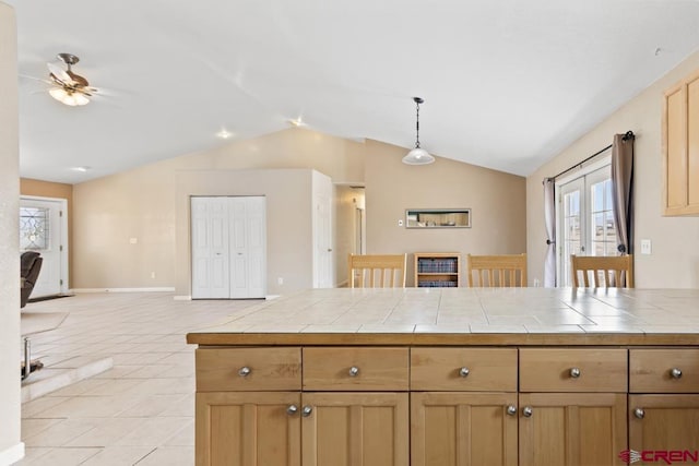19496 E Rd, Delta, CO 81416 - kitchen featuring open floor plan, tile counters, vaulted ceiling, a ceiling fan, and light tile patterned flooring
