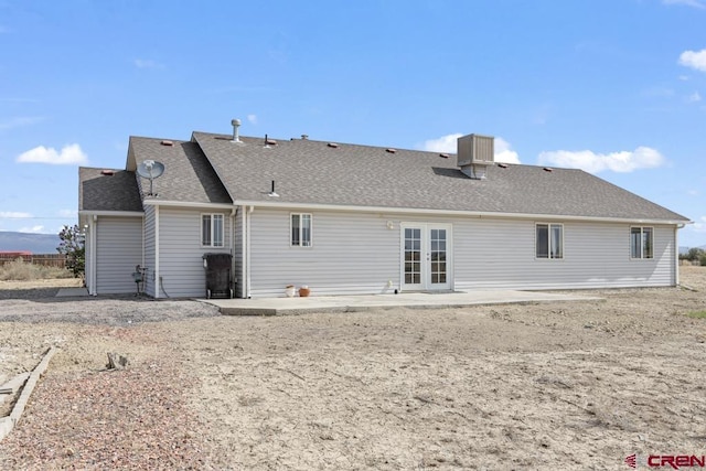 19496 E Rd, Delta, CO 81416 - rear view of house featuring french doors, a patio area, and a shingled roof