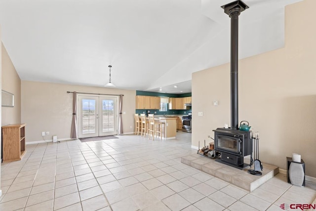 19496 E Rd, Delta, CO 81416 - unfurnished living room with a wood stove, lofted ceiling, light tile patterned floors, baseboards, and french doors
