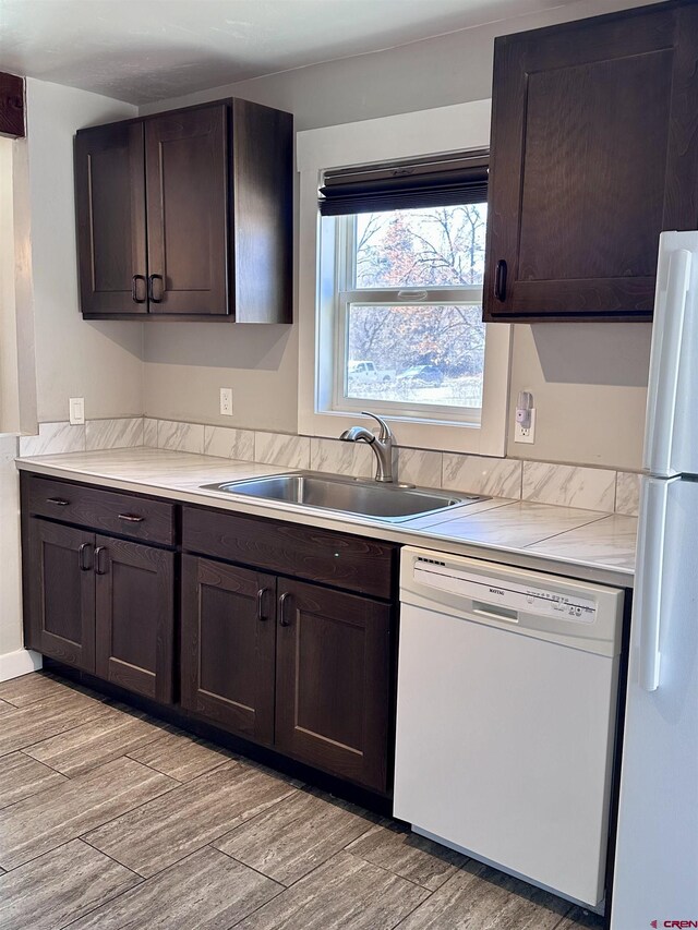 2375 W 2nd Ave, Durango, CO 81301 - kitchen with white appliances, a sink, dark brown cabinetry, and light wood finished floors