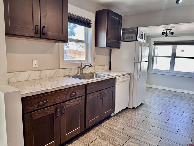 2375 W 2nd Ave, Durango, CO 81301 - kitchen featuring a sink, white appliances, dark brown cabinets, and light countertops