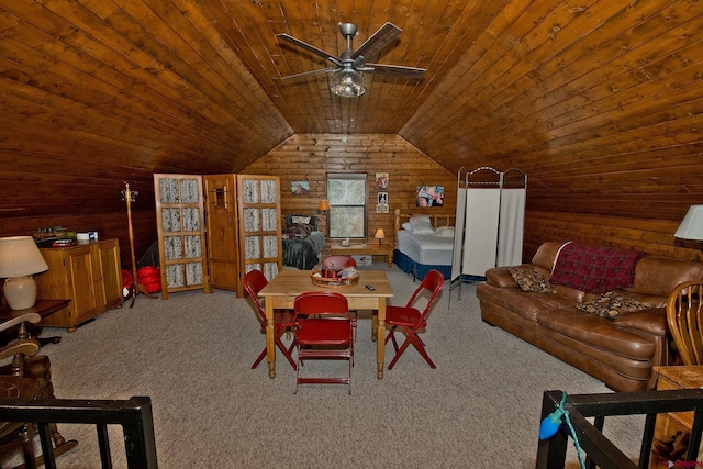 dining area with wooden ceiling, wood walls, carpet floors, vaulted ceiling, and ceiling fan