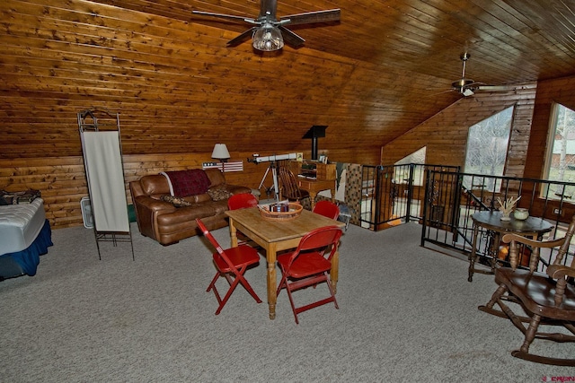 carpeted dining room featuring a ceiling fan, wooden ceiling, wood walls, and lofted ceiling
