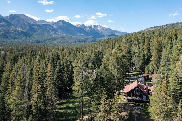 view of mountain backdrop with a heavily wooded area