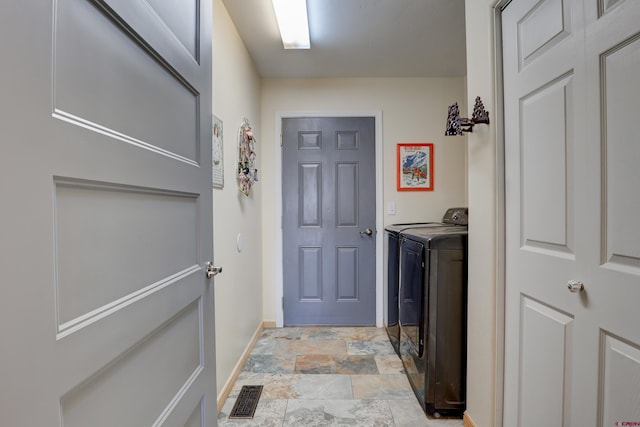 1546 Golf Course Ln, Cortez, CO 81321 - clothes washing area with baseboards, washing machine and dryer, and stone finish flooring