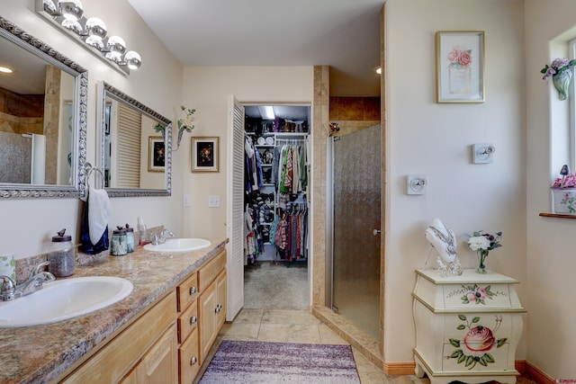 1546 Golf Course Ln, Cortez, CO 81321 - bathroom with a shower stall, a walk in closet, tile patterned floors, and double vanity