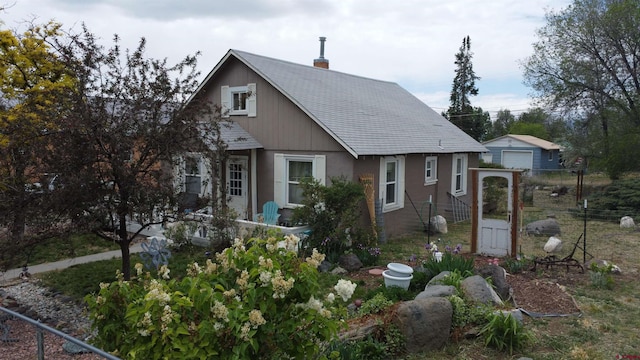 230 NW 5th St, Cedaredge, CO 81413 - view of front of home with a garage, a chimney, and a shingled roof
