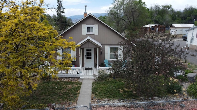 230 NW 5th St, Cedaredge, CO 81413 - bungalow with a fenced front yard and a chimney