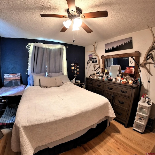 230 NW 5th St, Cedaredge, CO 81413 - bedroom with a textured ceiling, light wood finished floors, and a ceiling fan