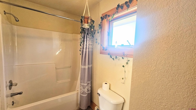 46 Camino Baca Grande, Crestone, CO 81131 - bathroom with a textured wall, shower / tub combo, and toilet