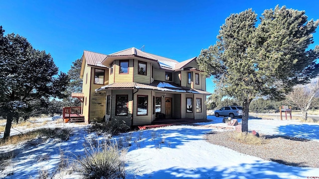 46 Camino Baca Grande, Crestone, CO 81131 - view of front of house featuring a porch, metal roof, and a standing seam roof