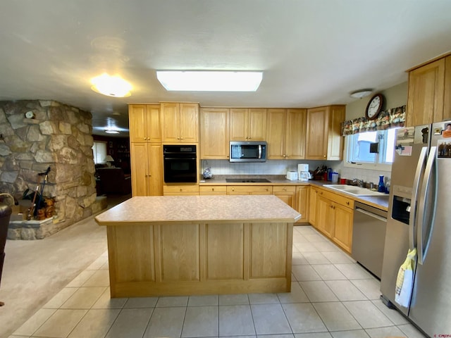622 Rio Vista Rd, Gunnison, CO 81230 - kitchen featuring black appliances, a sink, a center island, light countertops, and light tile patterned floors