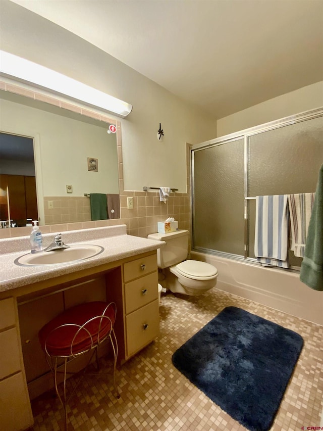 622 Rio Vista Rd, Gunnison, CO 81230 - bathroom featuring toilet, vanity, and enclosed tub / shower combo