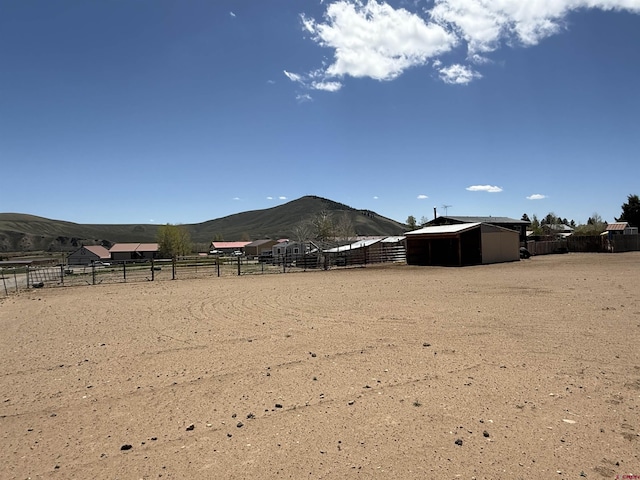 15 Tomichi Ln, Gunnison, CO 81230 - view of yard featuring a mountain view, an outdoor riding arena, and an outdoor structure