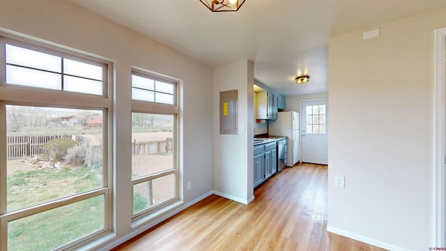 15 Tomichi Ln, Gunnison, CO 81230 - kitchen featuring blue cabinetry, light wood-style floors, baseboards, and dishwasher