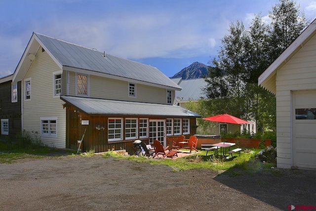 402 Sopris Ave, Crested Butte, CO 81224 - back of house featuring a hot tub, metal roof, and a mountain view