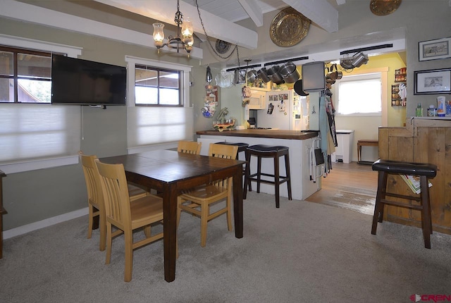 402 Sopris Ave, Crested Butte, CO 81224 - dining room featuring plenty of natural light, light carpet, a chandelier, and beamed ceiling