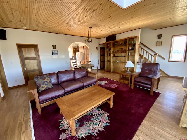 865 County Road 17, Gunnison, CO 81230 - living room featuring arched walkways, wood finished floors, stairs, baseboards, and wooden ceiling