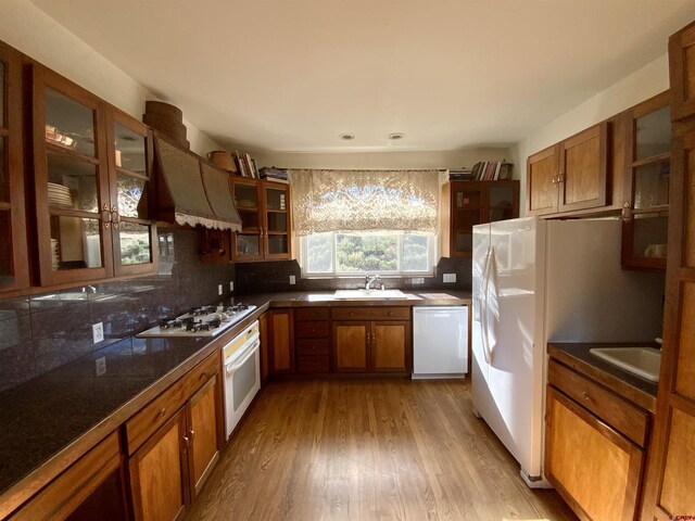 865 County Road 17, Gunnison, CO 81230 - kitchen with white appliances, premium range hood, a sink, brown cabinets, and recessed lighting