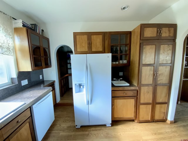 865 County Road 17, Gunnison, CO 81230 - kitchen featuring white appliances, arched walkways, light wood-style flooring, glass insert cabinets, and recessed lighting
