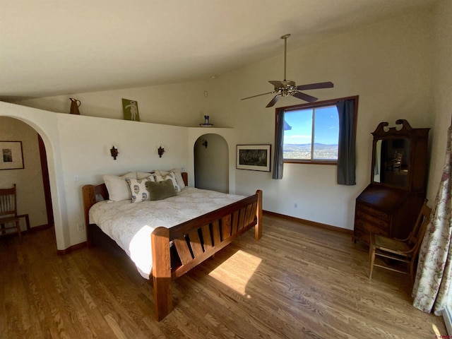 865 County Road 17, Gunnison, CO 81230 - bedroom with arched walkways, wood finished floors, vaulted ceiling, a ceiling fan, and baseboards