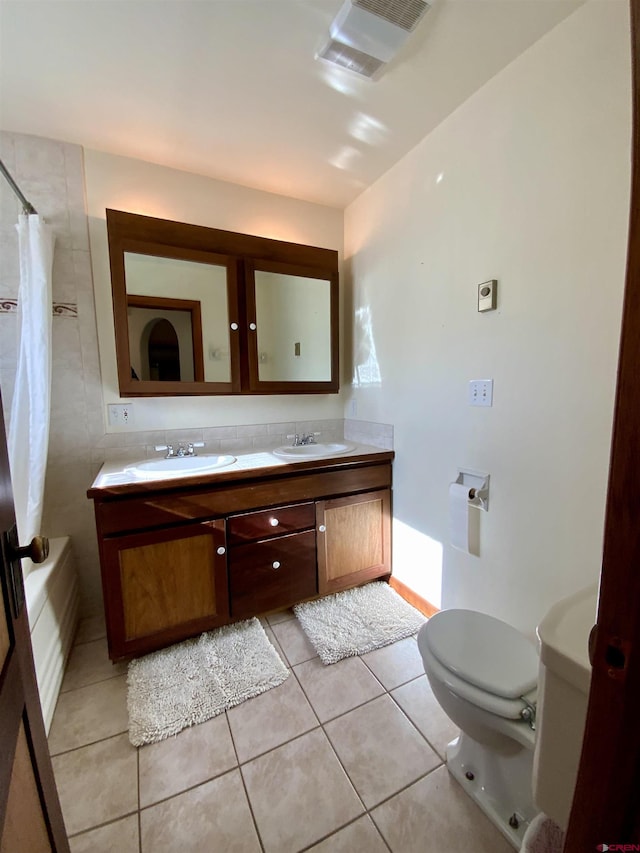 865 County Road 17, Gunnison, CO 81230 - bathroom with toilet, tile patterned floors, double vanity, and shower / bath combo with shower curtain