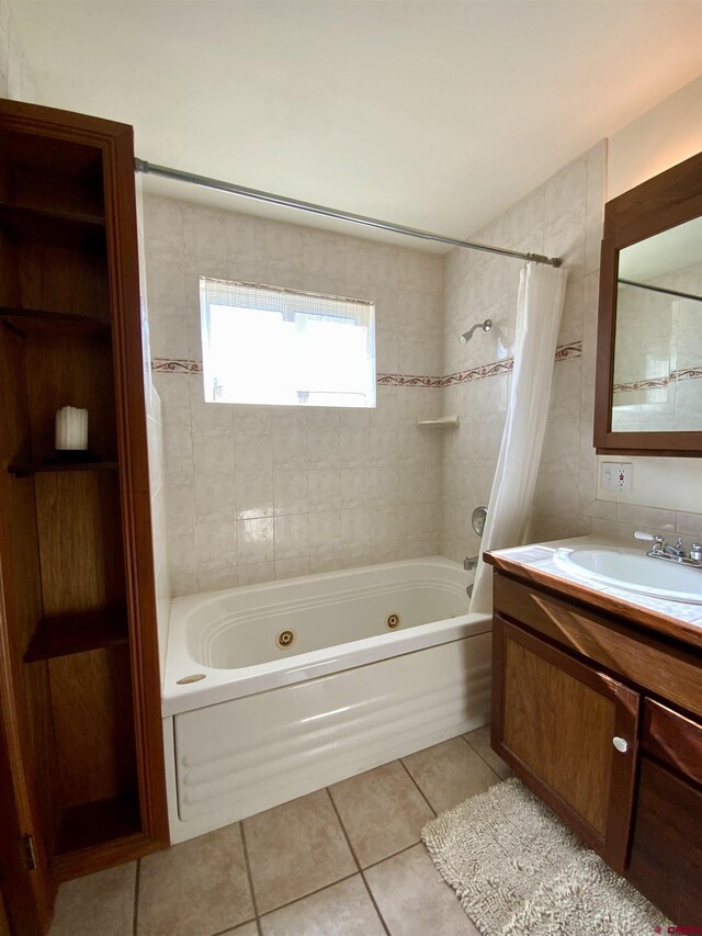 865 County Road 17, Gunnison, CO 81230 - bathroom featuring a combined bath / shower with jetted tub, tile patterned flooring, vanity, and tile walls