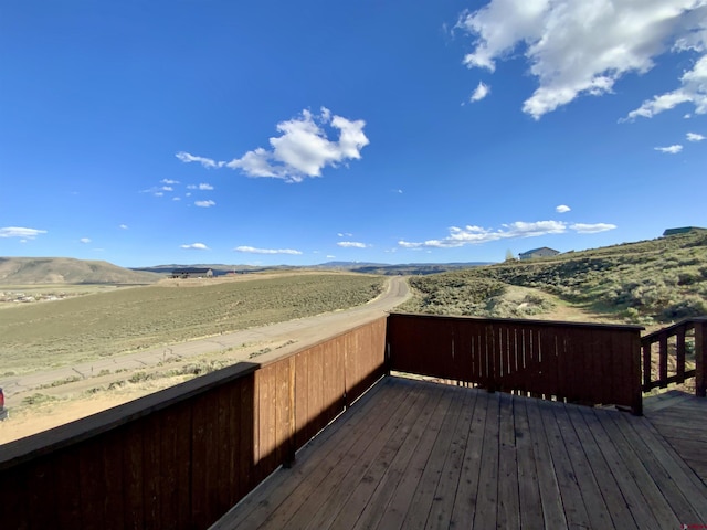 865 County Road 17, Gunnison, CO 81230 - wooden deck featuring a mountain view and a rural view
