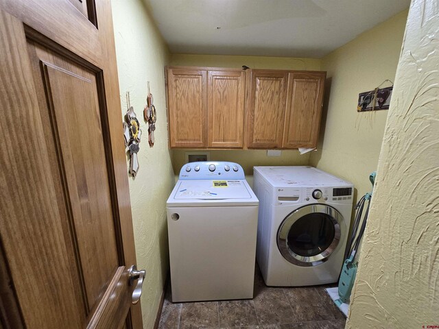 4189 Crowther Ln, Alamosa, CO 81101 - laundry room with washing machine and clothes dryer, cabinet space, and stone finish floors