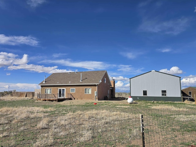 4189 Crowther Ln, Alamosa, CO 81101 - rear view of property with a deck, a pole building, and an outdoor structure