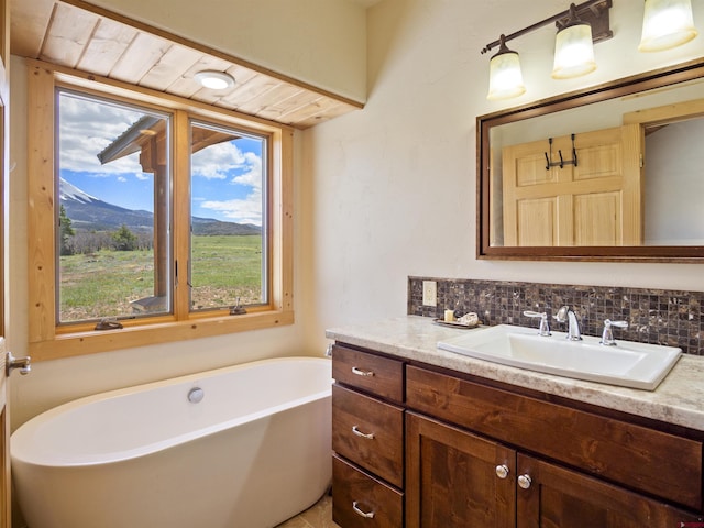741 Big Wall Ln, La Veta, CO 81055 - bathroom featuring vanity, a freestanding bath, and decorative backsplash