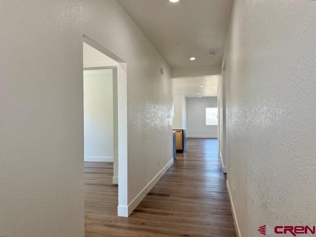 1911 Edison Ave, Alamosa, CO 81101 - hallway with a textured wall, wood finished floors, baseboards, and recessed lighting