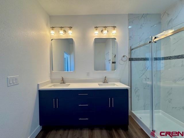 1911 Edison Ave, Alamosa, CO 81101 - full bath with wood finished floors, a marble finish shower, and double vanity