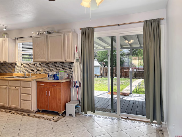 214 S Valley, Cortez, CO 81321 - kitchen with light tile patterned floors, backsplash, a sink, and a ceiling fan