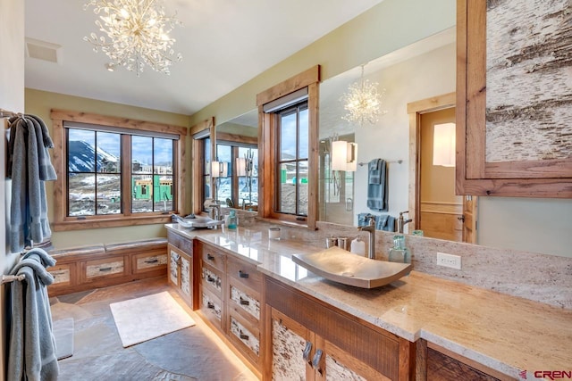 426 Saddle Ridge Ranch Rd, Crested Butte, CO 81224 - bathroom with a chandelier and double vanity