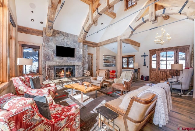 426 Saddle Ridge Ranch Rd, Crested Butte, CO 81224 - living area featuring a fireplace, wood finished floors, a chandelier, beam ceiling, and high vaulted ceiling