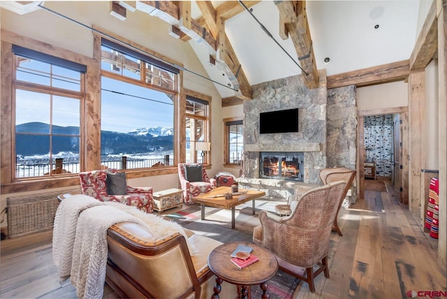 426 Saddle Ridge Ranch Rd, Crested Butte, CO 81224 - living area featuring hardwood / wood-style floors, high vaulted ceiling, a fireplace, and beam ceiling