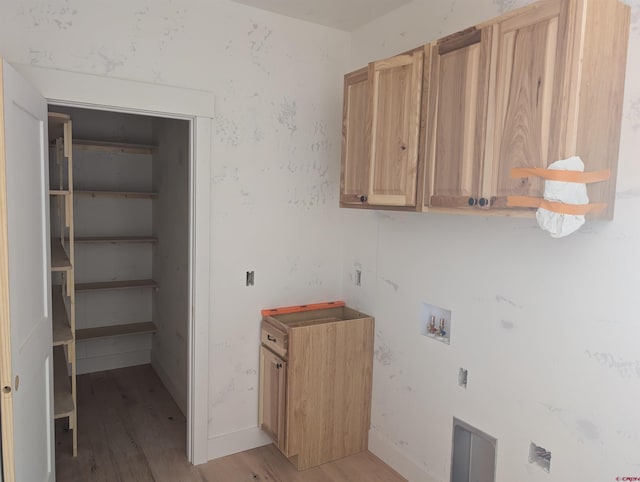54 Lakewood St, Pagosa Springs, CO 81147 - laundry room featuring cabinet space, light wood-style flooring, and washer hookup