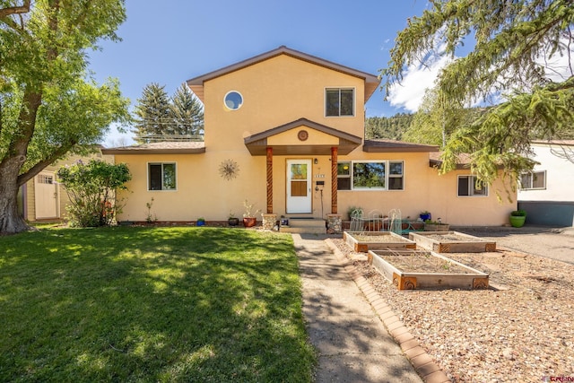 3515 Bennett St, Durango, CO 81301 - view of front facade featuring stucco siding, a garden, and a front yard