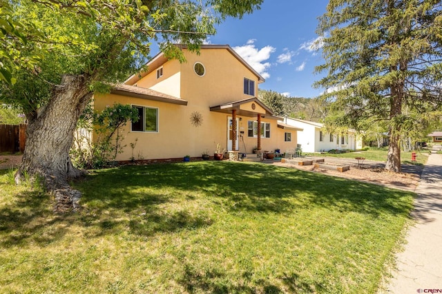 3515 Bennett St, Durango, CO 81301 - view of front facade featuring stucco siding, a front lawn, and a patio