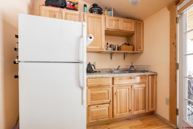 3515 Bennett St, Durango, CO 81301 - kitchen featuring freestanding refrigerator, light wood finished floors, light brown cabinets, a sink, and vaulted ceiling