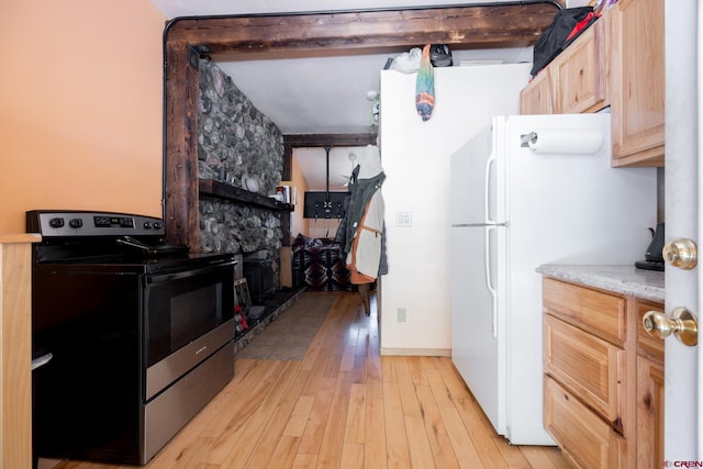 3515 Bennett St, Durango, CO 81301 - kitchen with electric stove, light brown cabinetry, light wood-style flooring, freestanding refrigerator, and light countertops