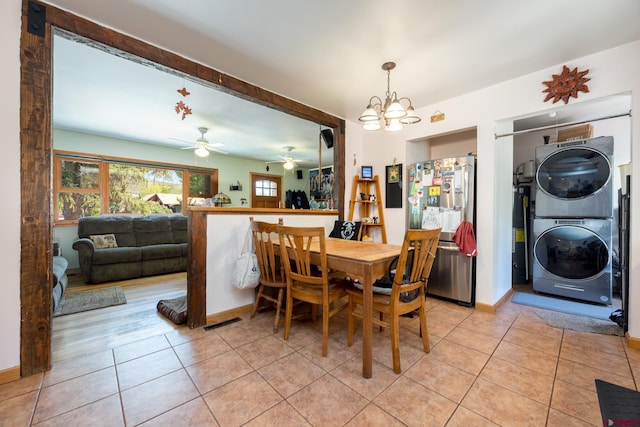 3515 Bennett St, Durango, CO 81301 - dining area with estacked washer and dryer, light tile patterned flooring, a ceiling fan, a chandelier, and baseboards
