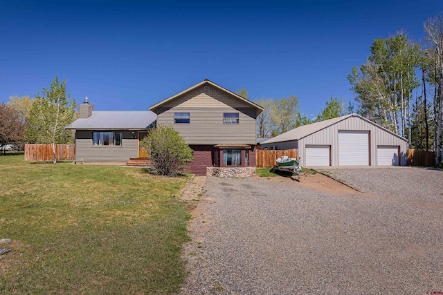 399 E Schroder Dr, Bayfield, CO 81122 - view of front of property with a detached garage, a chimney, an outbuilding, and metal roof