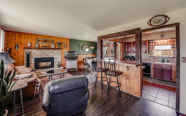 399 E Schroder Dr, Bayfield, CO 81122 - living room featuring wood walls, dark wood-style floors, and a stone fireplace