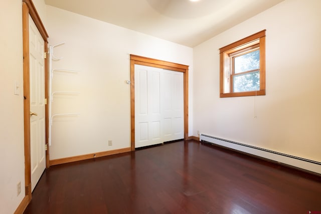 323 3rd Ave, Ouray, CO 81427 - unfurnished bedroom with a baseboard heating unit, dark wood-style floors, and baseboards