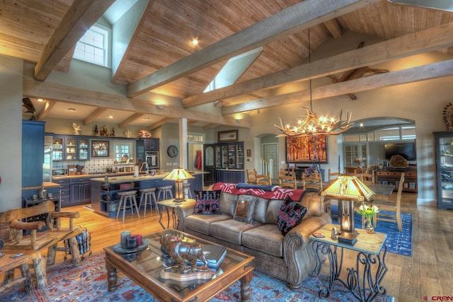 575 County Rd 253, Durango, CO 81301 - living room featuring arched walkways, a chandelier, light wood-type flooring, wood ceiling, and bar area
