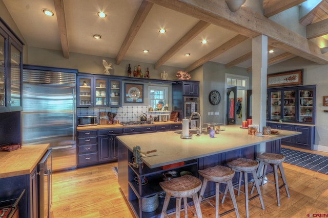 575 County Rd 253, Durango, CO 81301 - kitchen with stainless steel appliances, light wood-type flooring, wood counters, a breakfast bar, and recessed lighting