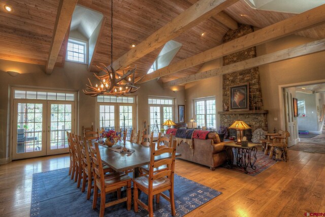 575 County Rd 253, Durango, CO 81301 - dining room with french doors, high vaulted ceiling, a chandelier, wooden ceiling with exposed beams, and wood finished floors